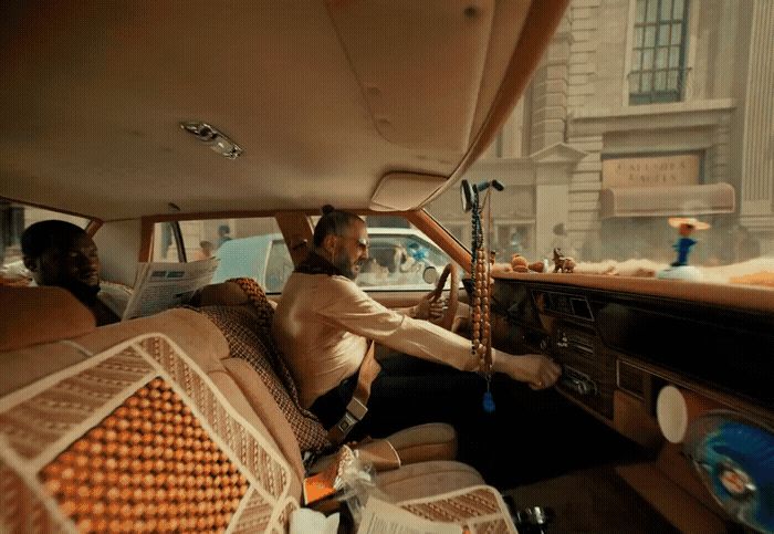 a man sitting in the driver's seat of a car