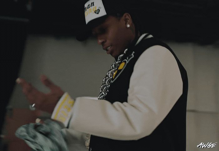 a young man wearing a white and black baseball cap