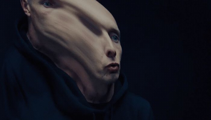 a man in a black hoodie with a strange look on his face