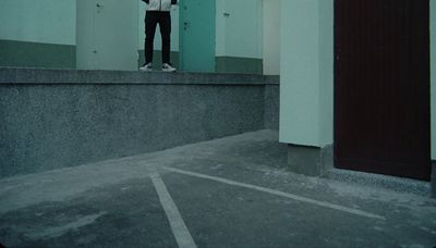 a person standing on a ledge with a skateboard