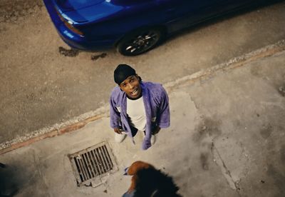 a man standing next to a dog on a sidewalk