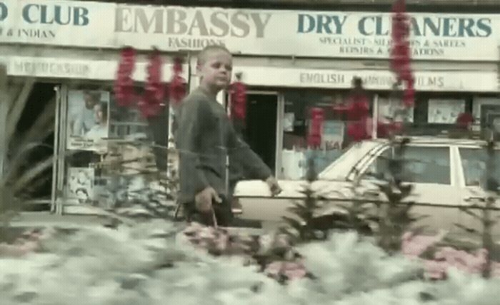 a man standing in front of a flower shop