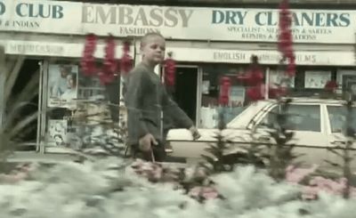 a man standing in front of a flower shop