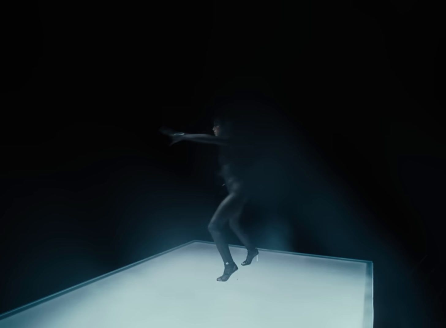 a person standing on a platform in the dark