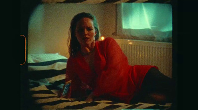 a woman in a red dress laying on a bed