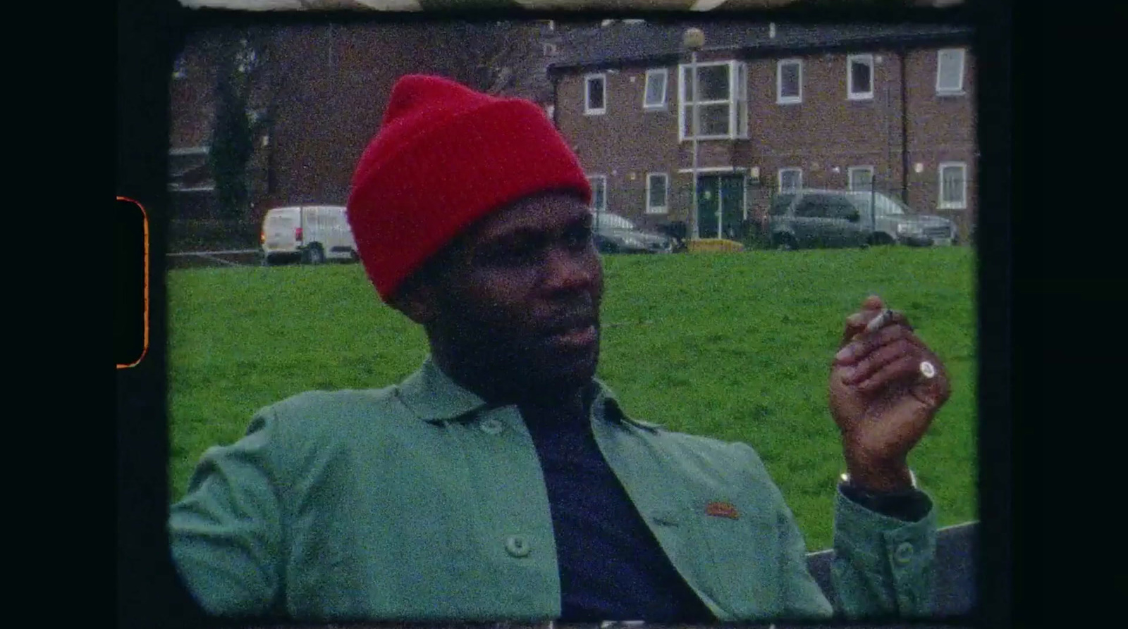 a man in a red hat smoking a cigarette