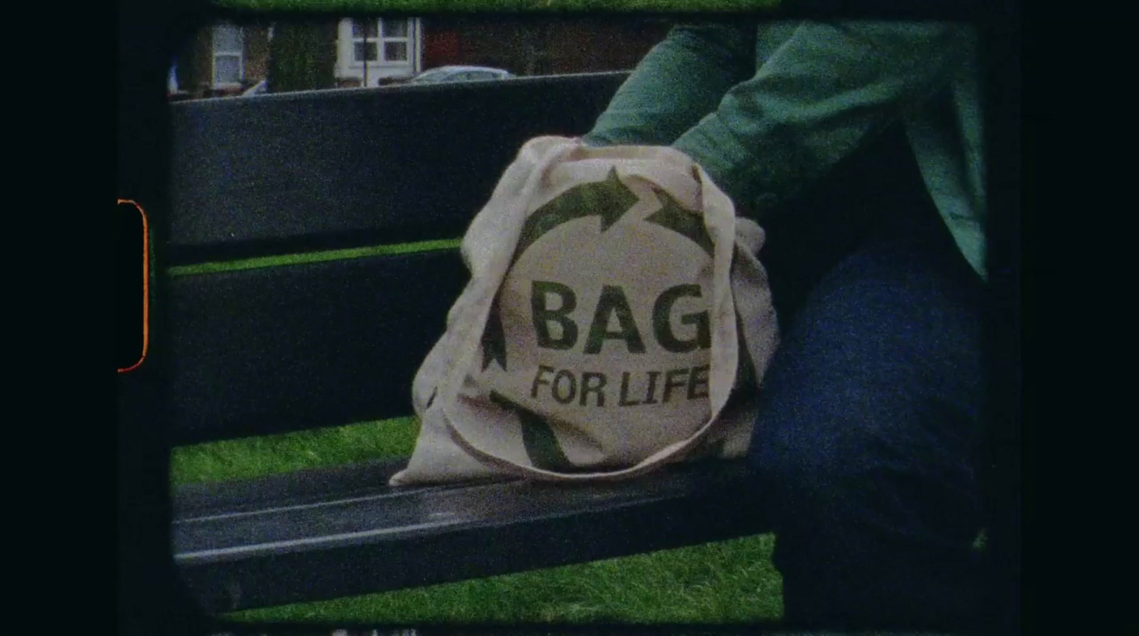 a person sitting on a bench with a bag