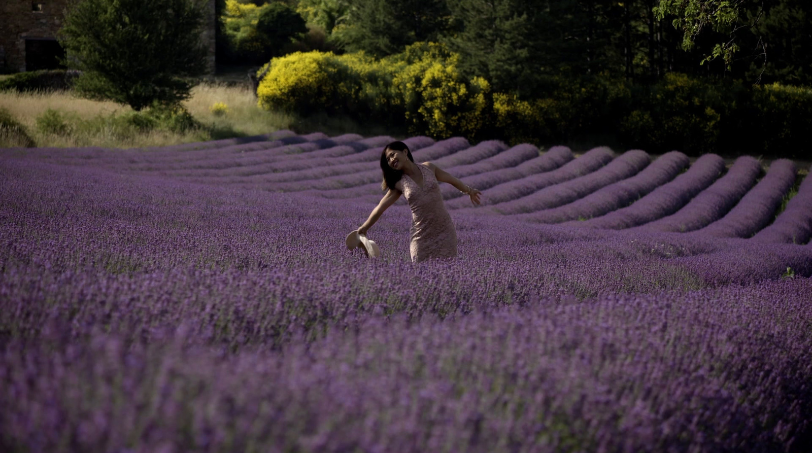 a woman in a field of lavender flowers