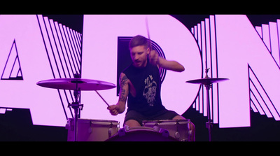 a man sitting on top of a drum set