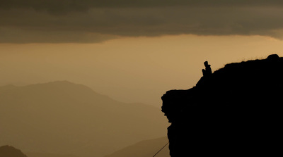 a person standing on top of a cliff