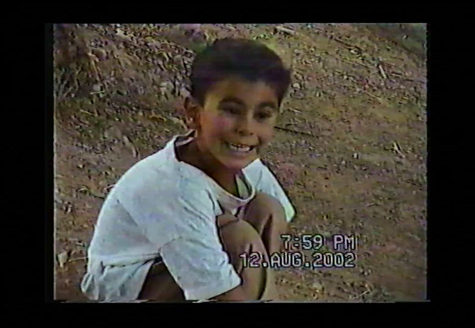 a young boy is smiling for the camera