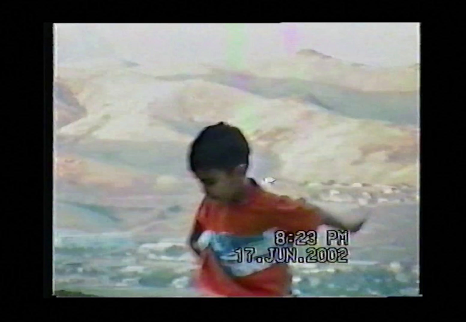 a young boy is running in the water