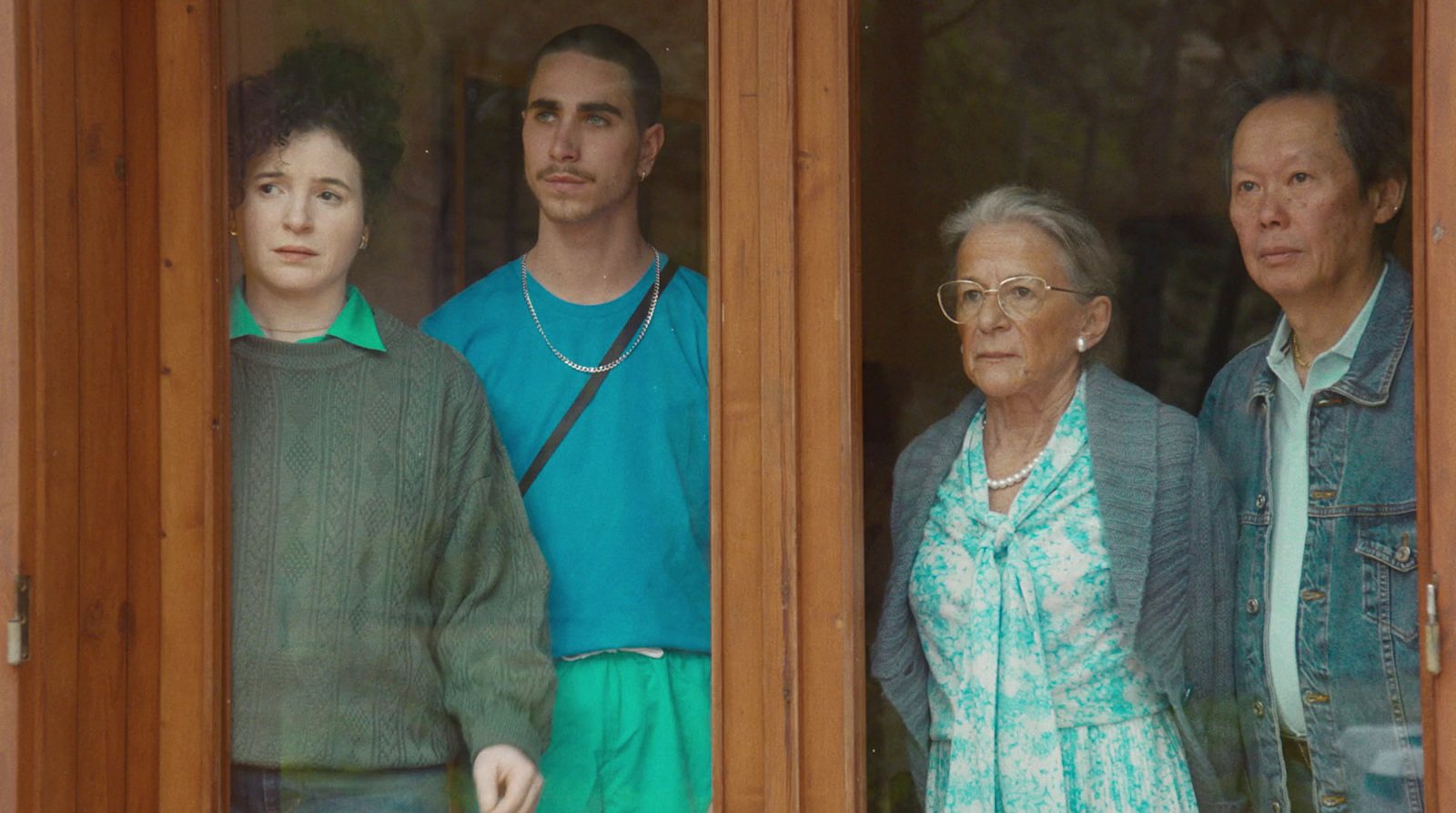 a group of people standing outside of a window