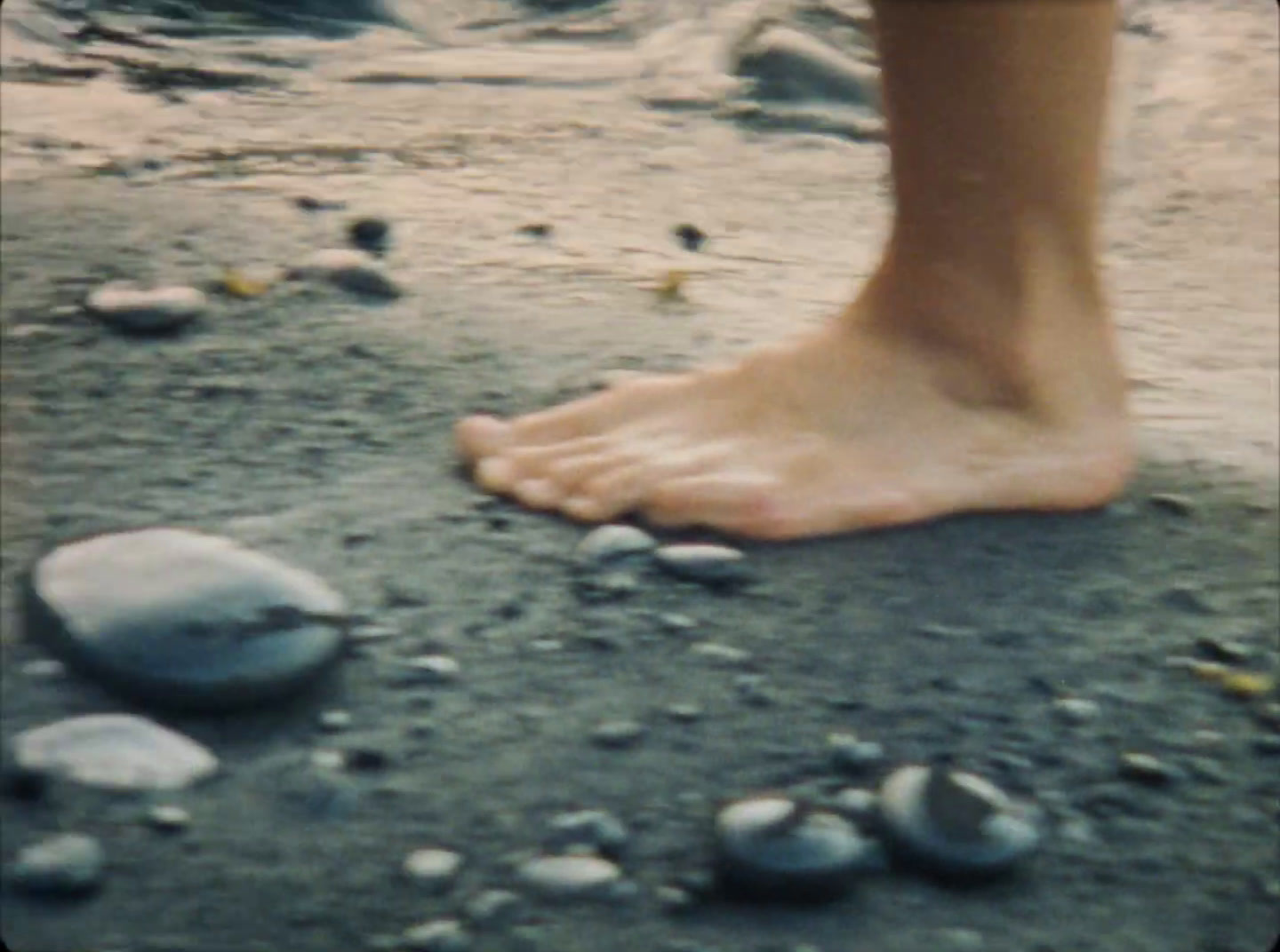 a person standing on top of a sandy beach