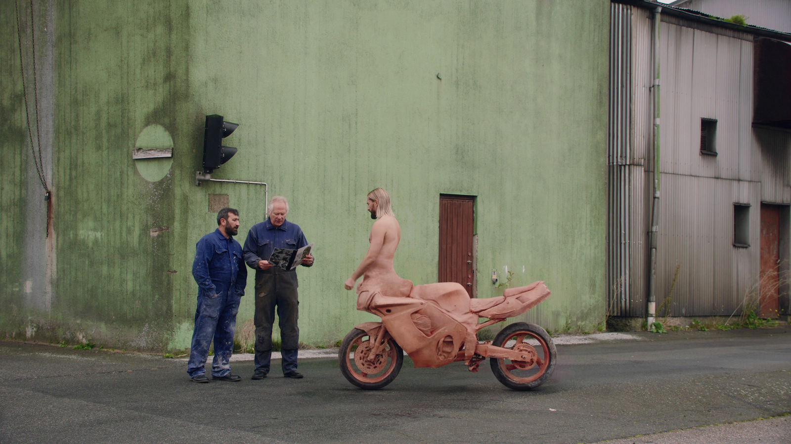 a man and a woman standing next to a pink motorcycle