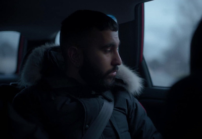 a man sitting in the back seat of a car