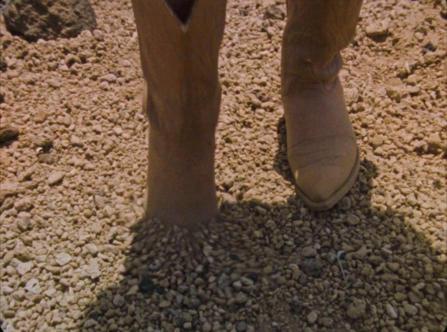 a close up of a person's feet in a pair of boots