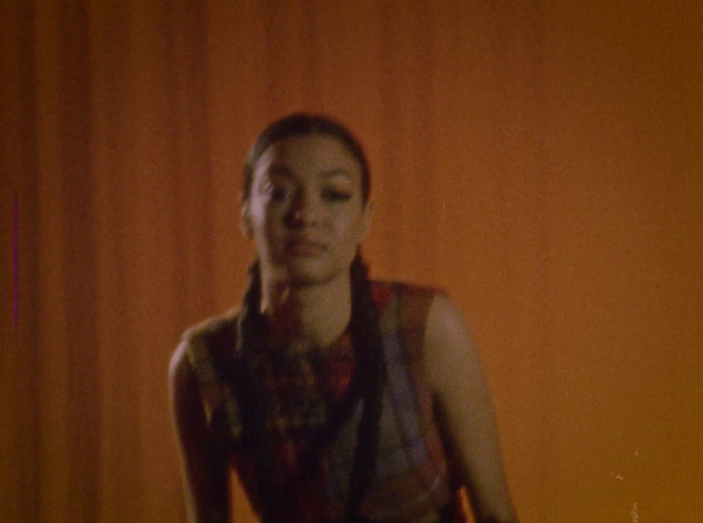 a woman standing in front of a red curtain