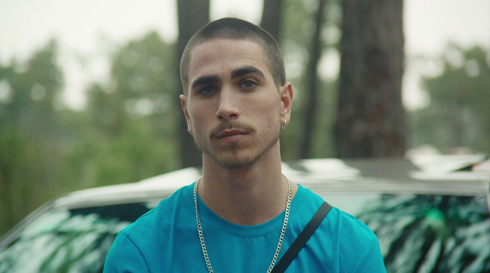 a man standing in front of a parked car