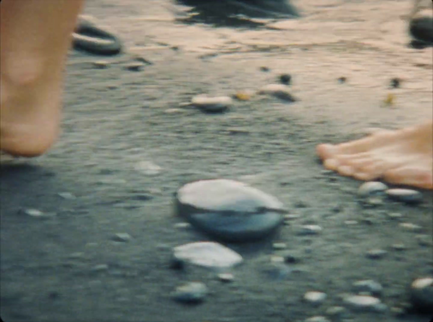 a close up of a person walking on a beach