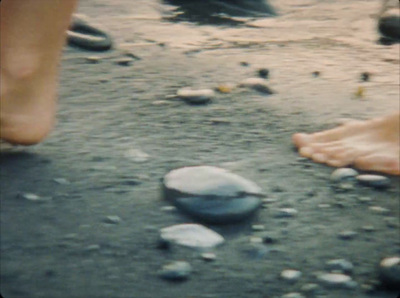 a close up of a person walking on a beach