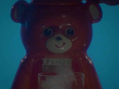 a brown teddy bear holding a glass of water