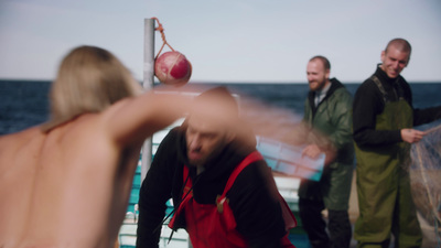 a group of people on a boat near the water