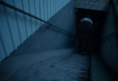 a person walking up a flight of stairs at night