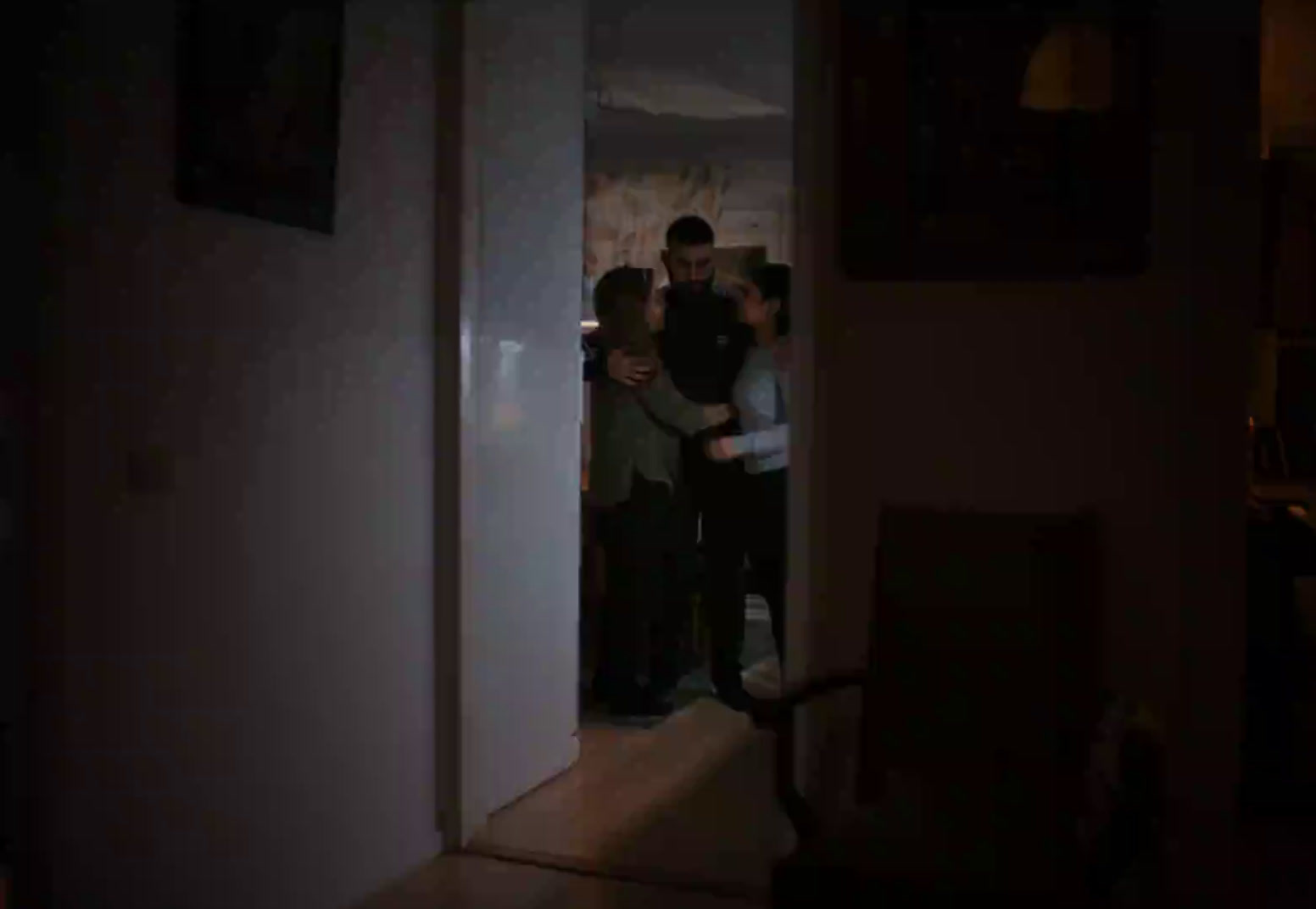 a group of people standing in a doorway at night