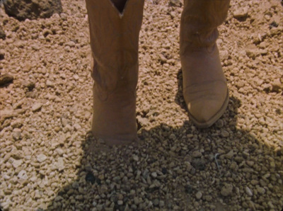 a person's feet in a pair of cowboy boots