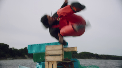 a man is doing a trick on a boat