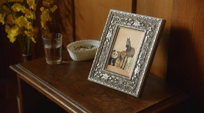 a picture frame sitting on top of a wooden table