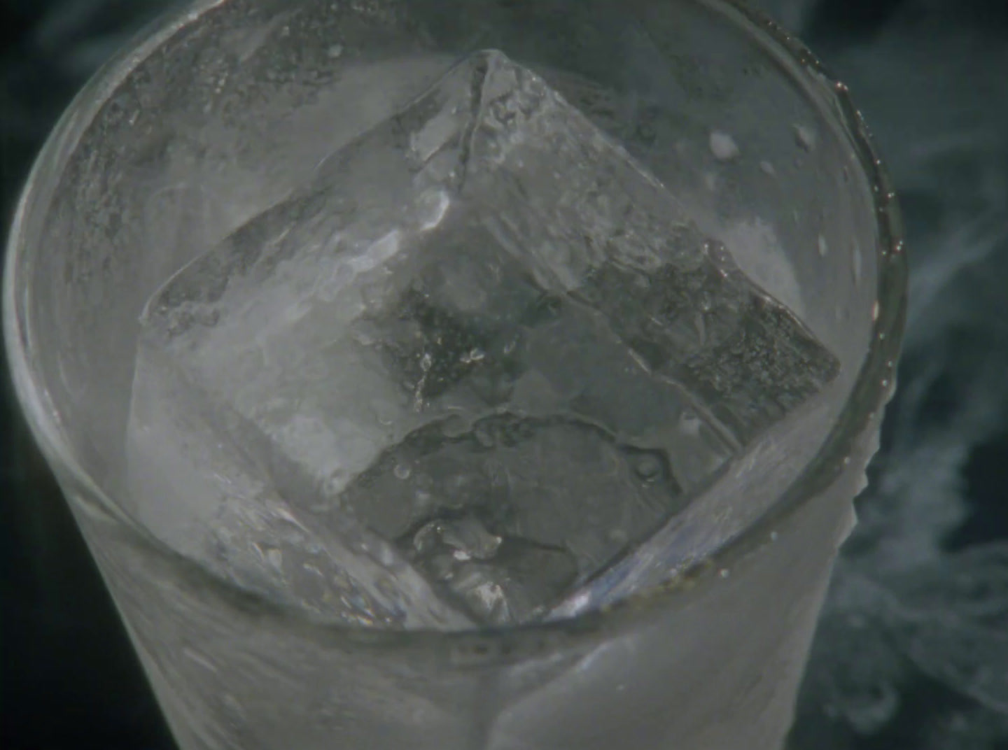 an ice cube in a glass of water