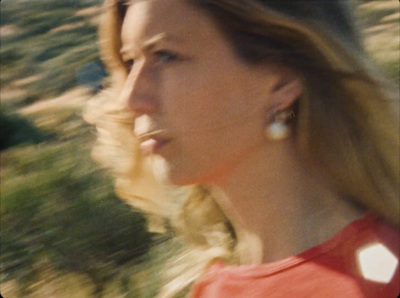 a blurry photo of a woman in a red shirt