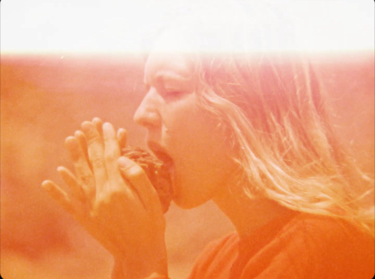 a woman eating a doughnut with her hands