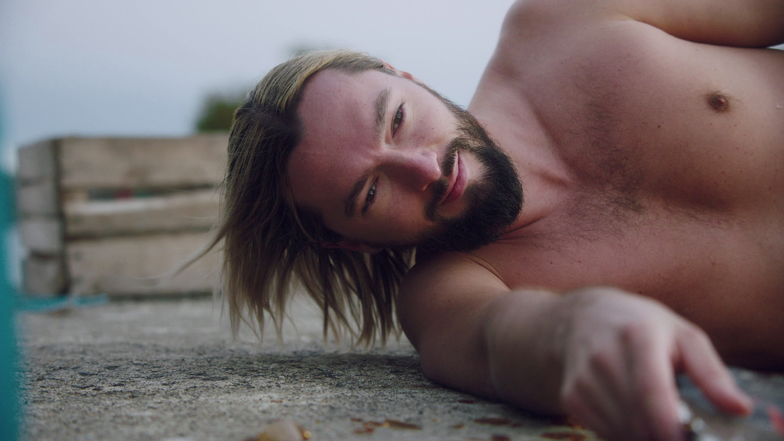 a man laying on the ground with no shirt on