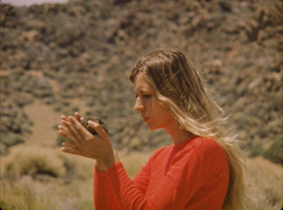 a woman holding a bird in her hands