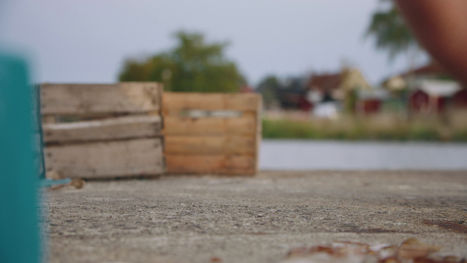 a wooden crate sitting on top of a cement ground