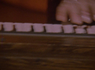 a close up of a person typing on a keyboard