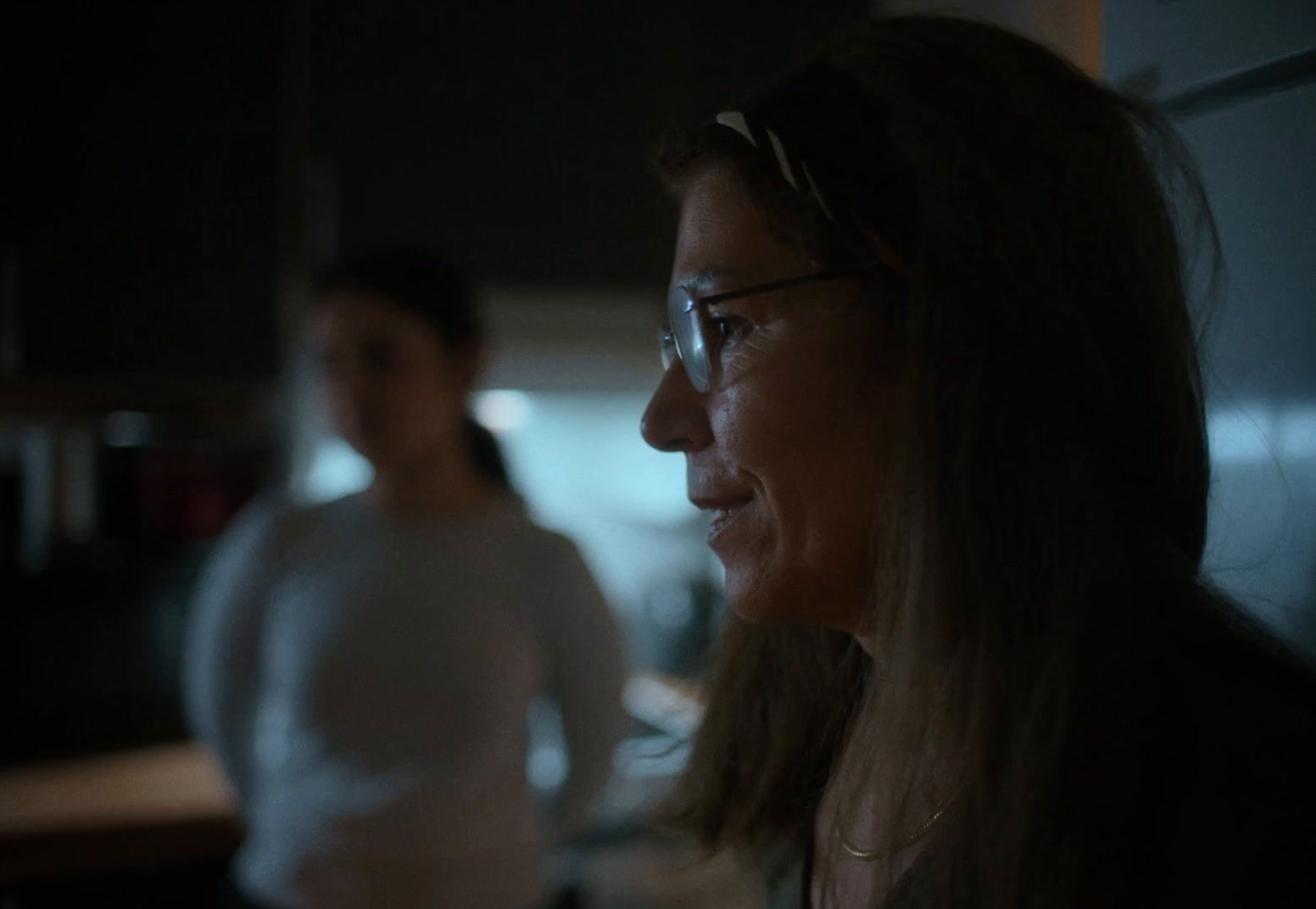 a woman standing next to a man in a kitchen