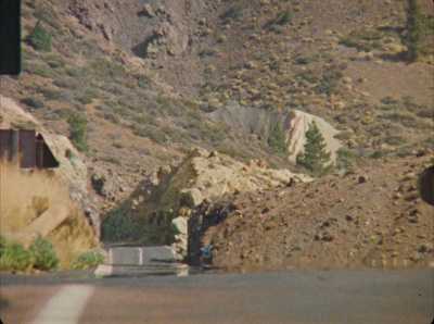 a road with a mountain in the background