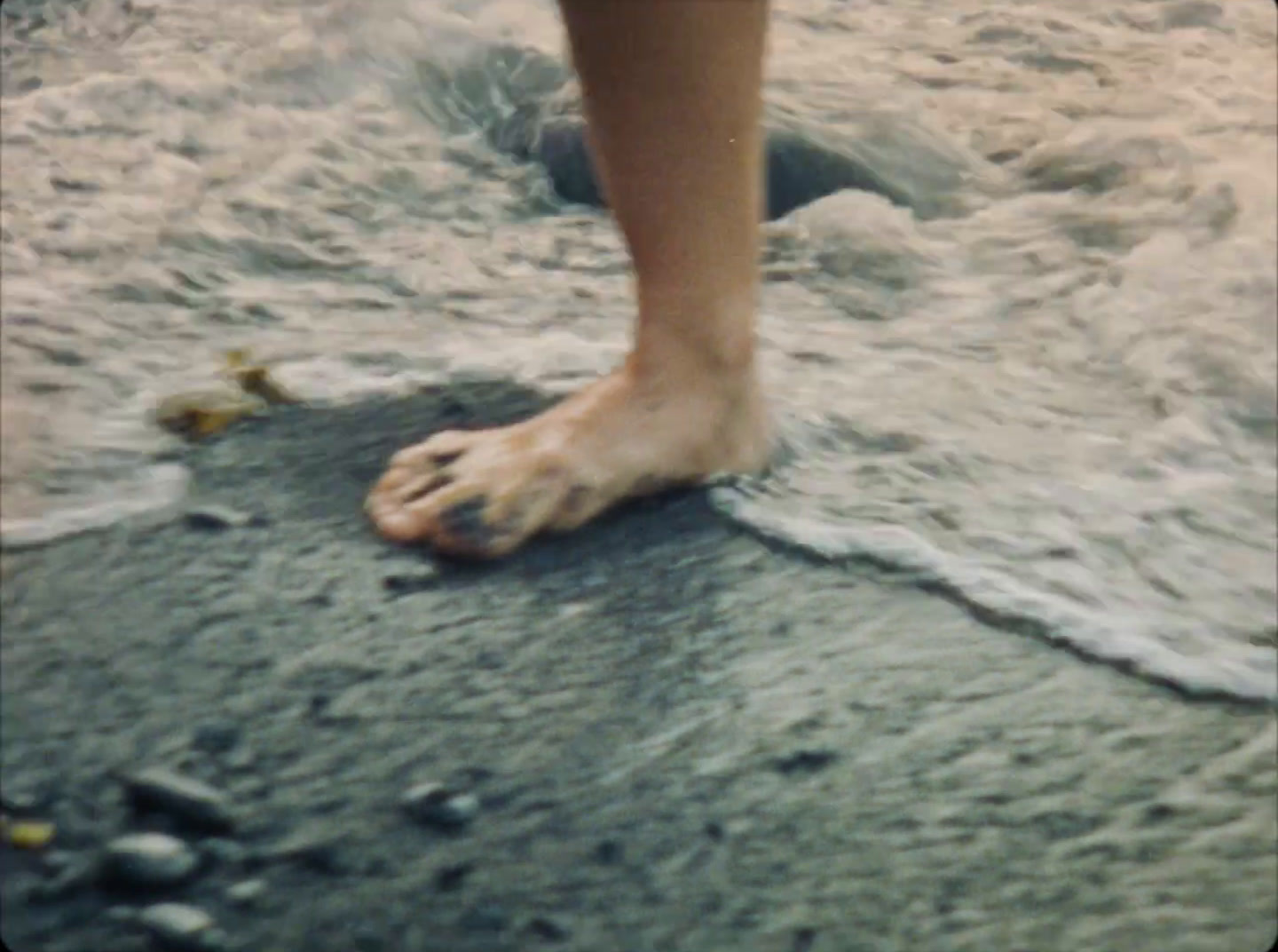 a person standing on top of a sandy beach