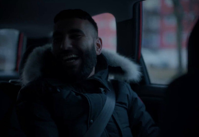 a man sitting in the back seat of a car