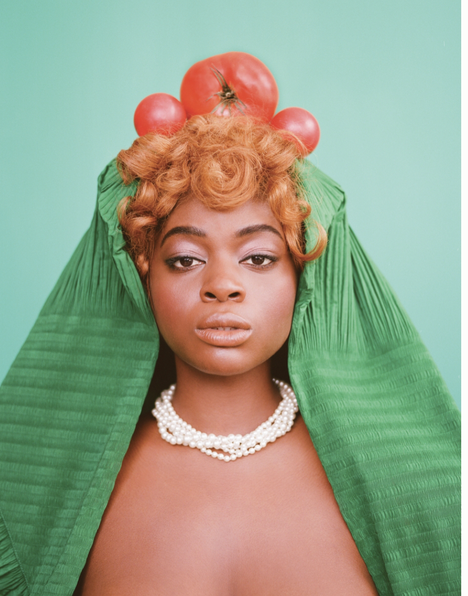 a woman with tomatoes on top of her head