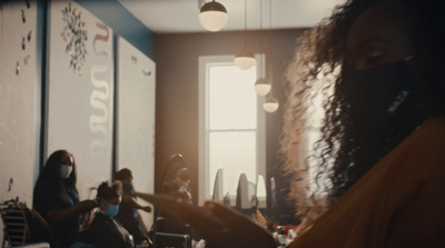 a woman wearing a face mask in a salon