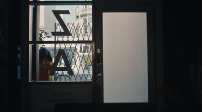 a woman is looking out of a window