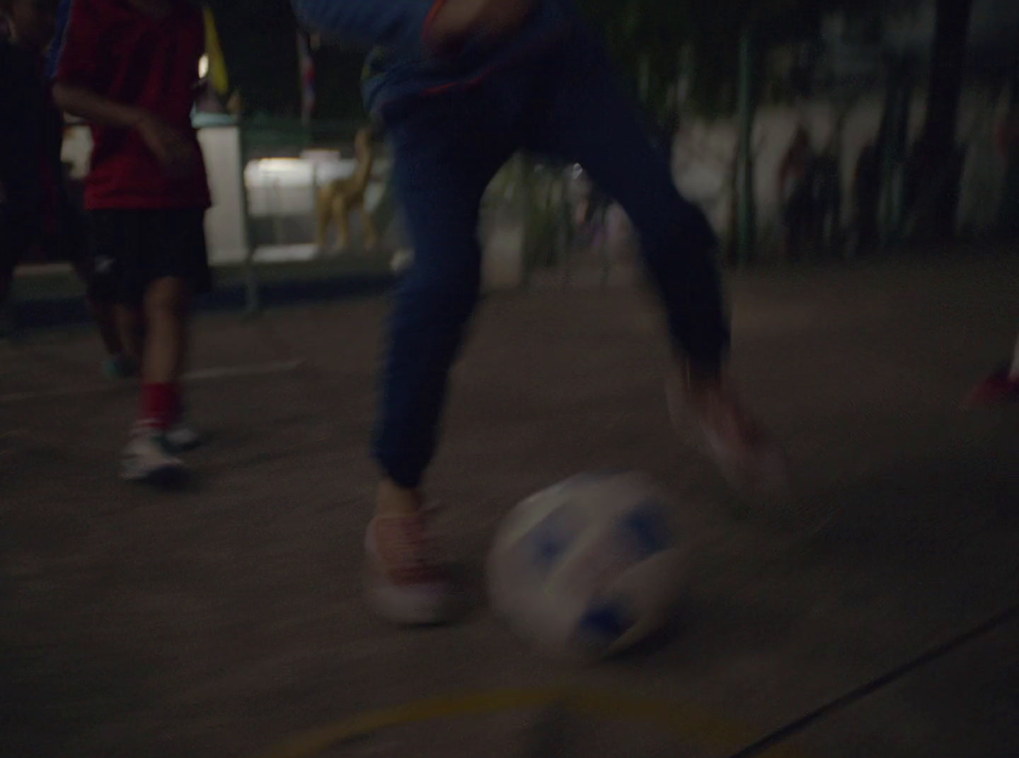 a blurry photo of a person kicking a soccer ball