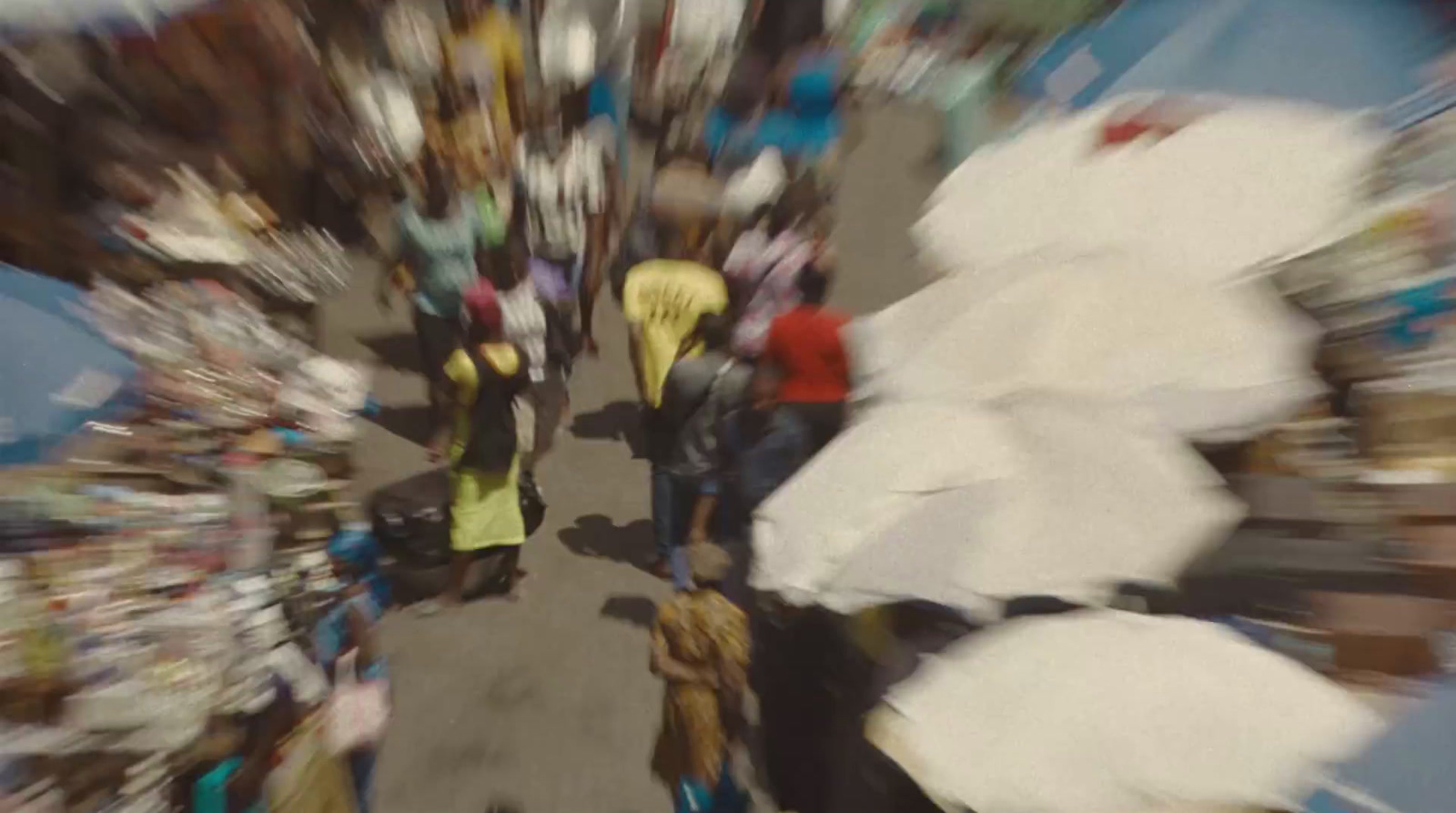 a group of people walking down a street holding umbrellas