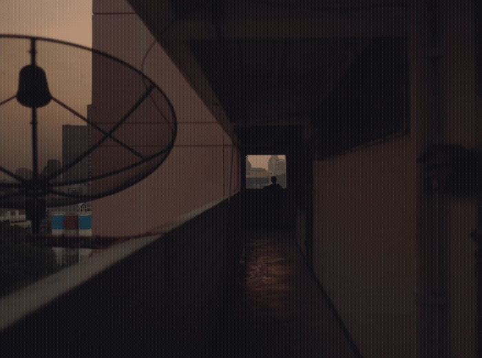 a dark hallway with a fan on the side of it