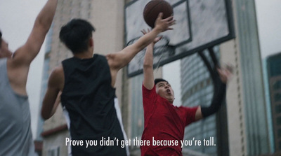 a group of young men playing a game of basketball